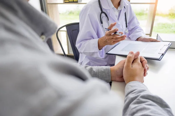 Paciente escuchando atentamente a un médico masculino explicando — Foto de Stock