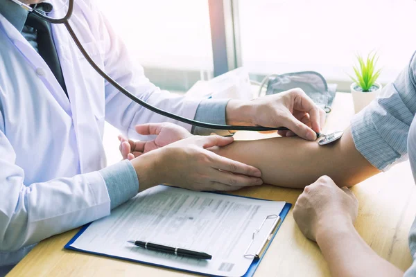 doctor hands checking blood pressure of a patient, Medical care concept