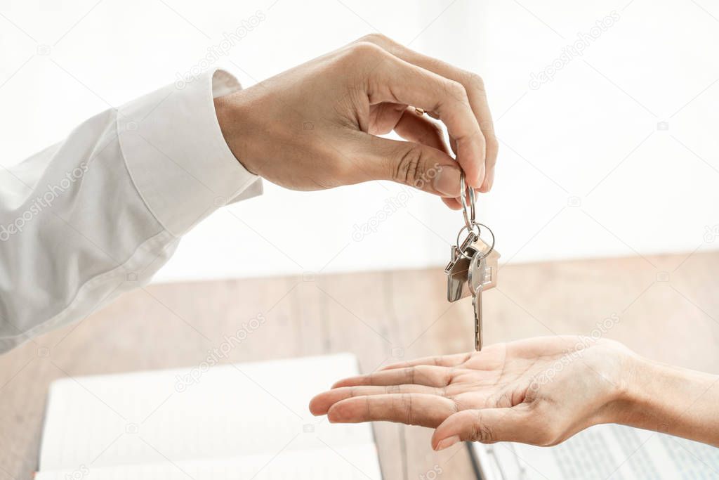 Real Estate developer Agent and sign on document giving keys of 