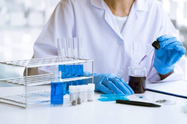 Bilim adamları laboratuvar önlüğü giyiyorlar ve koruyucu giysiler deney, laboratuvar ve geliştirme konseptinde deney tüpleriyle araştırma veya araştırma yapıyorlar..
