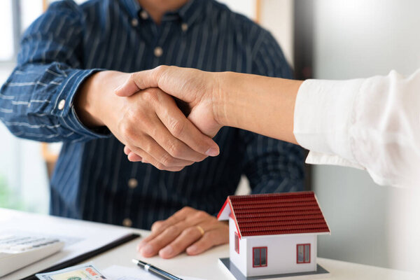 House developers and customer shaking hand after accept agreement finish buying or rental real estate for transfer right of property
