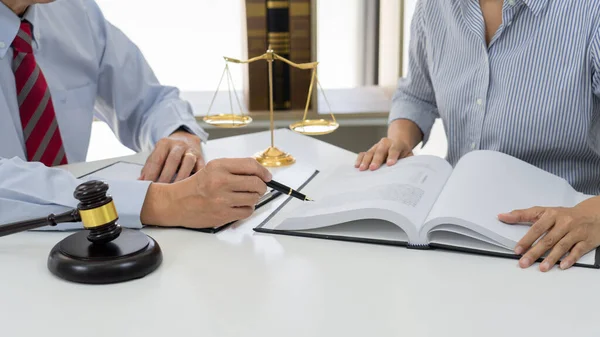 Client with his partner lawyers or attorneys discussing discussing a document or contract agreement working at table in office, Good service cooperation