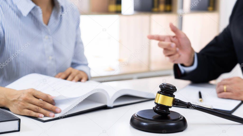 Client with his partner lawyers or attorneys discussing discussing a document or contract agreement working at table in office, Good service cooperation 