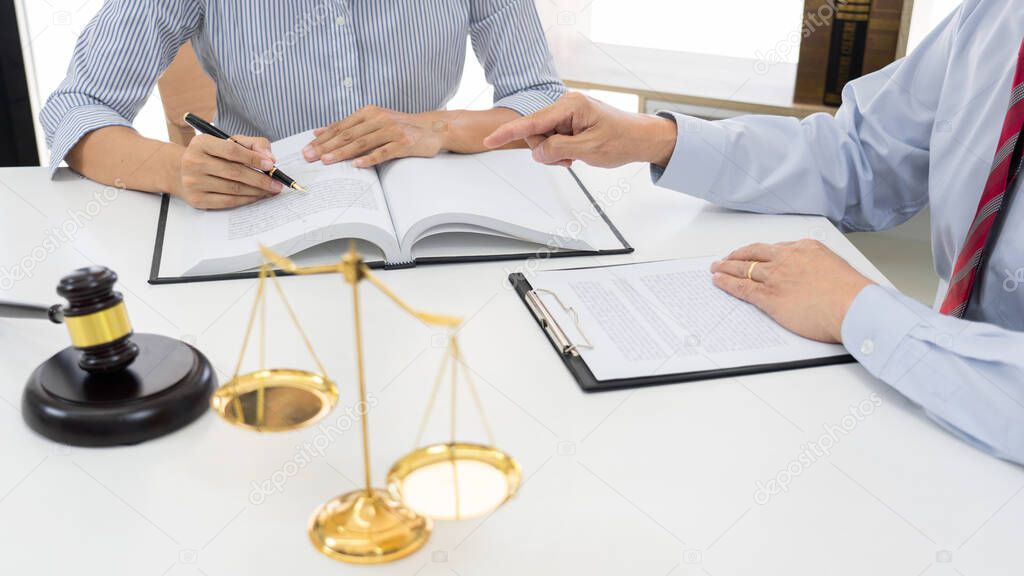 Client with his partner lawyers or attorneys discussing discussing a document or contract agreement working at table in office, Good service cooperation 