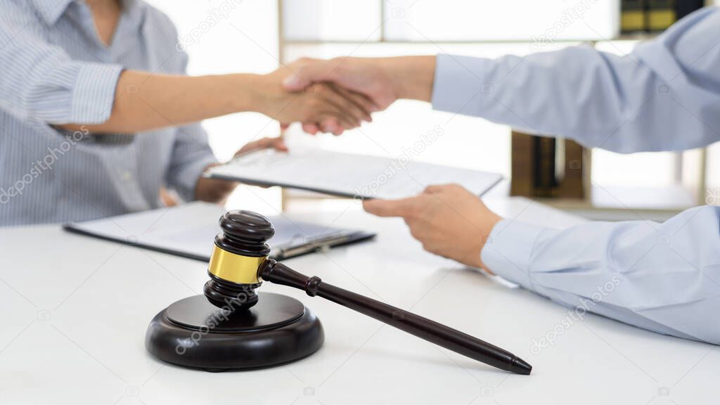 Handshake after cooperation between attorneys lawyer and clients after consultation discussing a contract agreement customer at courtroom, judge service concept