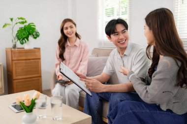 Expert Asian financial advisor offers personalized home consultation. Guiding clients on secure investments retirement planning wealth growth goals.