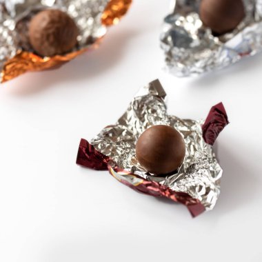 Çikolatalı pralin folyo sarılmış. Beyaz arka plan üzerinde izole