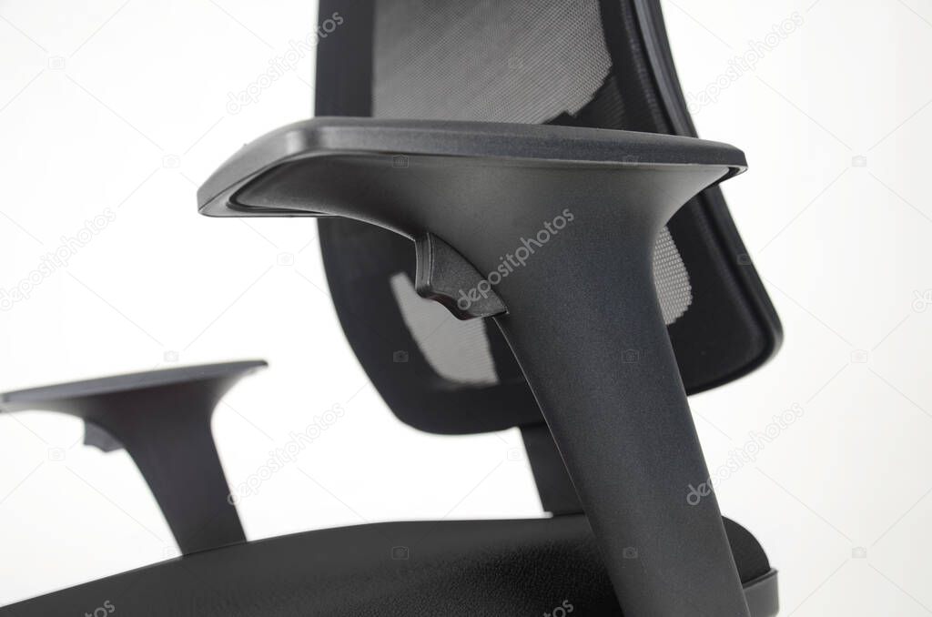 Close up on adjustable arm rest of black leather office chair. Isolated on white. Side view.