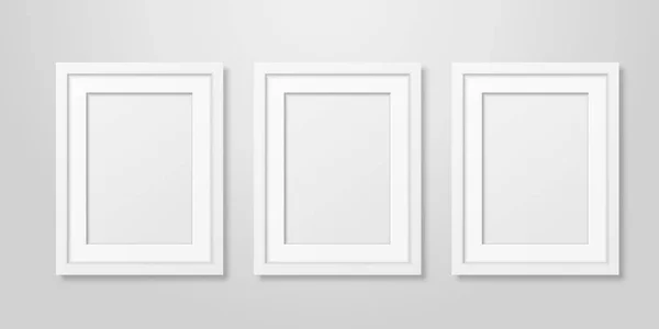 Tiga Vector Realistic Mofern Interior White Blank Vertical A4 Wooden Poster Picture Frame Set Closeup on White Wall Mock-up (dalam bahasa Inggris). Templat Desain Poster Kosong untuk Mockup, Presentasi - Stok Vektor