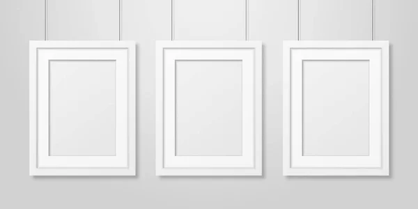 Three Vector Realistic Modern Interior White Blank Vertical A4 Wooden Poster Picture Frame Set Hanging on the Ropes on White Wall Mock-up. Empty Poster Frames Design Template for Mockup, Presentation — Stock Vector