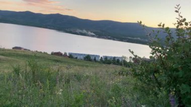 Gün batımında dağlarda bir dağ gölü olan panoramik bir manzara. Rahatlama, uyum, anti-stres konsepti. Gün batımı. Lagoon