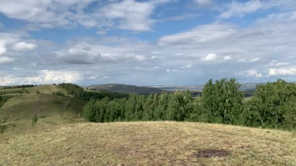 Beautiful panoramic view from the mountain to the summer landscape. Mountains, mountain lake, forests, fields. Top view. Somewhere in Russia. — Stock Video