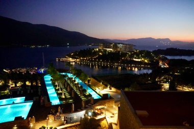 Türkiye 'nin Bodrum kenti yakınlarındaki Guverjinlink köyündeki Ege gölünün güzel gece manzarası. Deniz suyu havuzlarının ve otellerin güzel aydınlanması. Ege gölünün güzel gece manzarası.