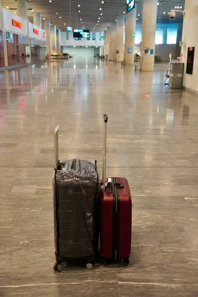 Two suitcases in the arrival hall at the airport, Travel concept. Lost luggage, Travelling concept