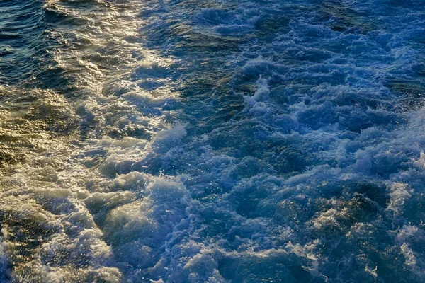 Borbulhando ondas azuis de vestígios de navios de cruzeiro turístico passando no Bósforo. Trilha aquática espumando atrás de um barco de balsa de passageiros em Bosphorus, Istambul, Turquia. — Fotografia de Stock