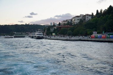 İstanbul gün batımında ufuk çizgisi, Türkiye. İstanbul 'un güzel şehir manzarası ve yolcu gemileri. İstanbul 'da yaz günü gün batımında seyahat ve tatil