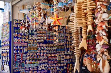Bodrum, Turkey - August, 2020: Atmospheric local souvenir markets. Turkish Grand Bazaar. Hand-made souvenirs at street market. Souvenirs: wind music, dream catcher, evil eye keychain, beads, bracelets clipart