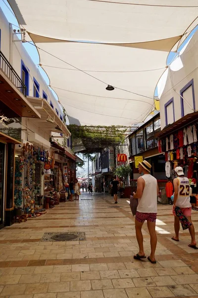 Bodrum, Türkiye - Ağustos 2020: Bodrum 'daki Marina Körfezi pazarındaki turistler dar sokaklarda hediyelik eşya görüyorlar. Turistler için dükkanlar. Gezginler için otantik mallar. Bodrum 'da hediyelik eşya. Doğu aromalı ve... — Stok fotoğraf