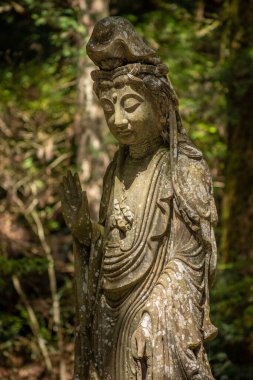 Buddhist sculpture in the Okunoin cemetery in Koyasan Mount Koya, UNESCO world heritage site and a 1200 years old center of Japanese sect of of Shingon Buddhism in Wakayama Japan clipart