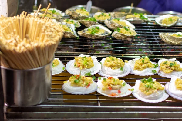 Oysters on the street market food stall in Luoyang Old City, Luoyang, Henan Province, China