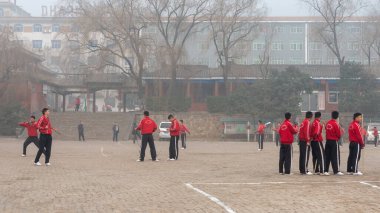 Shaolin, Luoyang, Henan Eyaleti / Çin - 4 Ocak 2016: Şaolin Tapınağı 'ndaki Şaolin Kung Fu okulunun bahçesinde genç çıraklar eğitimi