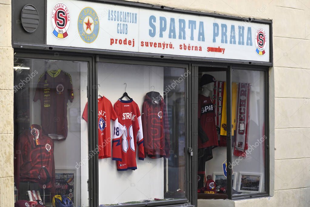 Storefront of Sparta Prague Football Club displaying sports merchandise for sale, featuring jerseys and scarves, in Prague, Czech Republic on 10 January 2024