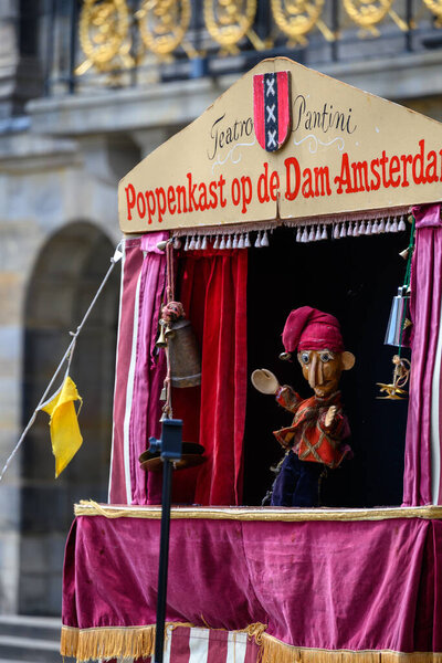 Puppet show booth with a puppet in Dam Square in Amsterdam, Netherlands on 20 July 2025