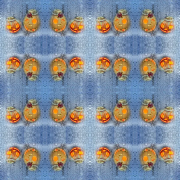 Colorful seamless texture with funny pumpkins on the background of the drops. The Concept Of Halloween