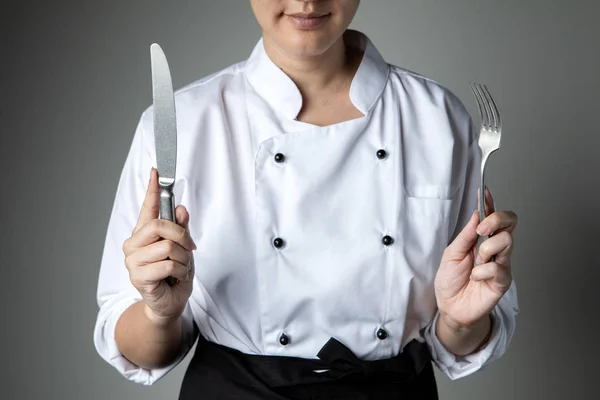 chef hand fork knife cooking prepare  food  in kitchen restaurant