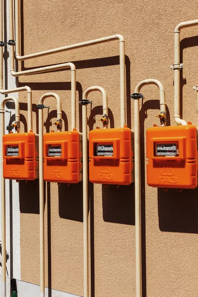 A number of residential meters of natural gas on an external wall for measuring energy consumption in households. The inscription: GAZ on the hull. Selective focus