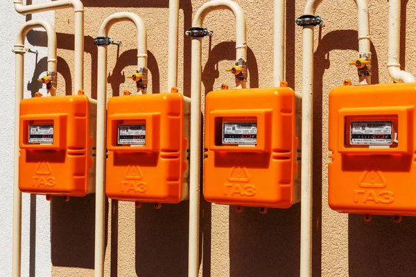 A number of residential meters of natural gas on an external wall for measuring energy consumption in households. The inscription: GAZ on the hull. Selective focus