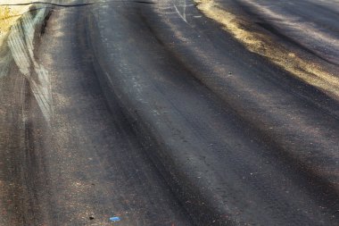 Bozuk yol çukurların ve nokta ile kıyılmış asfalt zarar görmüş. Çok kötü asfalt yol ile büyük trenche. Korkunç teknoloji yol asfalt üretim. Yumuşak asfalt ısı erir