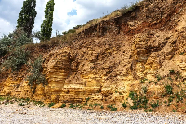 Landslide zone on Black Sea coast. Rock of sea rock shell. Zone of natural disasters during rainy season. Large masses of earth slip along slope of hill, destroy houses. Landslide - threat to life