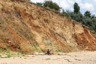 Karadeniz kıyısındaki heyelan bölgesi. Deniz taşı kabuğu. Yağmur mevsiminde doğal afetler bölgesi. Büyük toprak kütleleri tepenin yamacında kayıp evleri yok ediyor. Heyelan - yaşam tehdidi