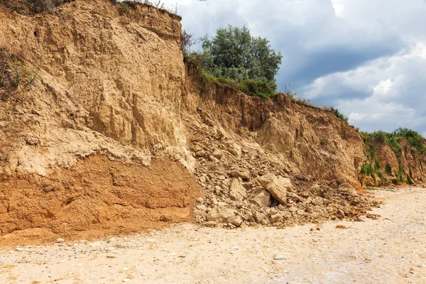 Landslide zone on Black Sea coast. Rock of sea rock shell. Zone of natural disasters during rainy season. Large masses of earth slip along slope of hill, destroy houses. Landslide - threat to life