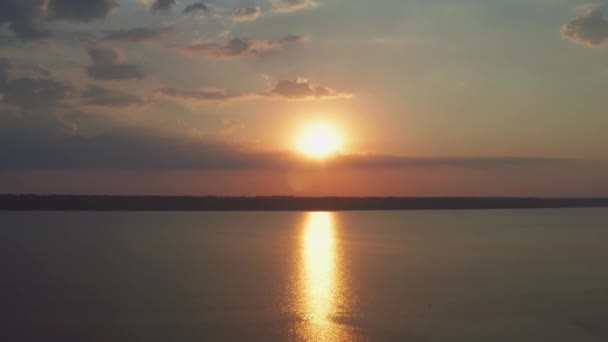 一架无人驾驶相机的空中照片金色的日落阳光灿烂的一天 在水面上有光路的大太阳盘 水面上的小浪花 — 图库视频影像