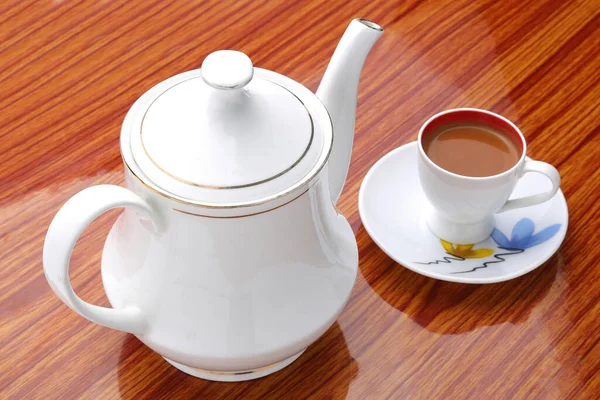 Tea.,Tea.,Milk tea in cup with teapot on wooden background