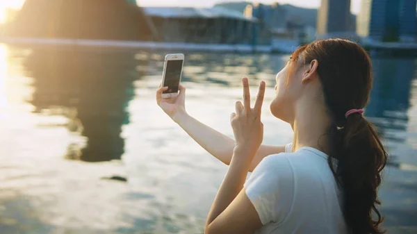 Asian girl using smart phone selfie