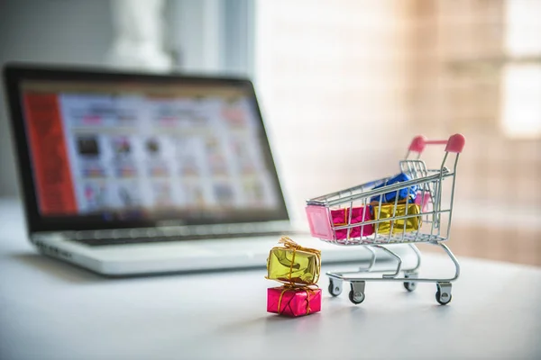 Shopping cart and computer - online shopping (e-commerce)