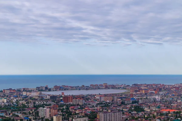 Panorama of the seaside city with a lake in the middle. Cloudy sky background.