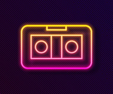 Parlayan neon hattı VHS video kaset ikonu siyah arkaplanda izole edildi. Vektör İllüstrasyonu