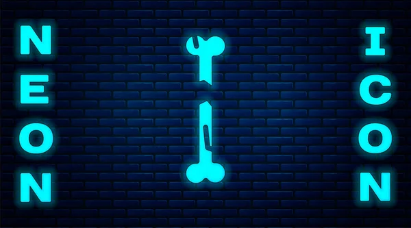 Glödande neon Mänskligt brutet ben ikon isolerad på tegel vägg bakgrund. Vektor — Stock vektor