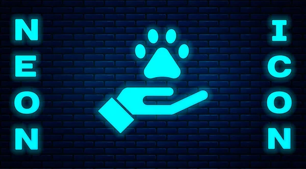 Glowing neon Hands with animals footprint icon isolated on brick wall background. Pet paw in heart. Love to the animals. Vector — Stock Vector