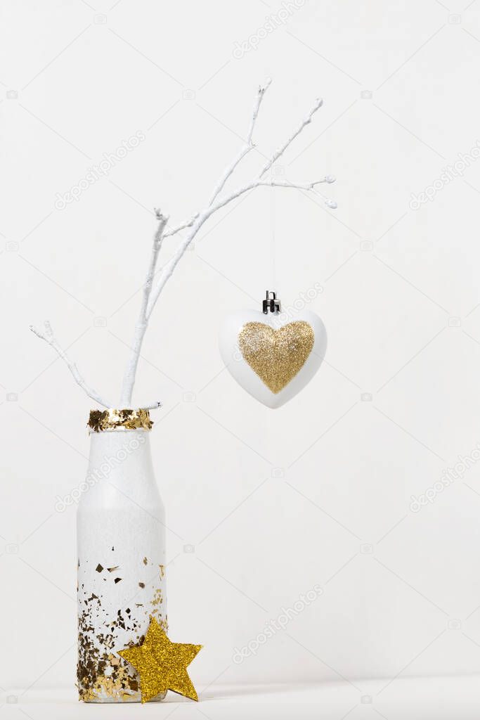 christmas decoration on tree branch in vase on white background