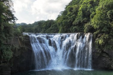 Shifen waterfall view. The waterfall is located near Shifen old town and the water connects to keelung river. Taiwan. clipart