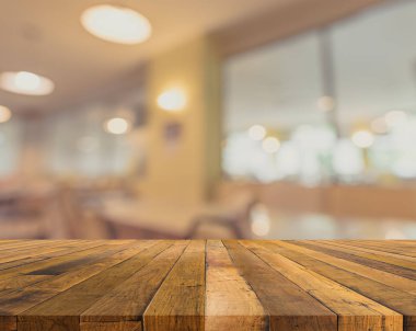 Arkaplan kullanımı için ahşap masa ve bulanık restoran yüzeyine seçici odaklı ton görüntüsü .