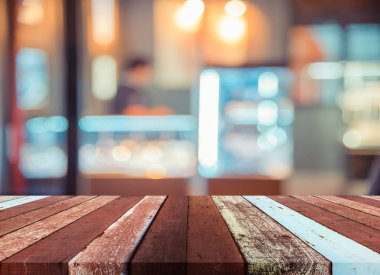 Arkaplan kullanımı için ahşap masa ve bulanık restoran yüzeyine seçici odaklı ton görüntüsü.