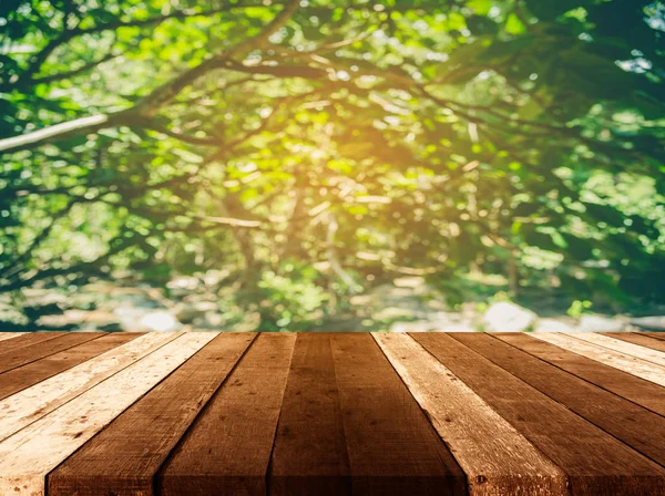 wood table and blur image of tree.