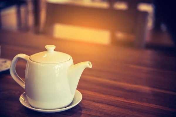 White teapot on wood table. — Stock Photo, Image