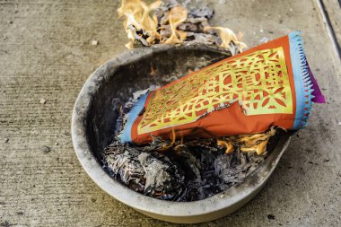 Burning fake gold in the Chinese New Year's Day . clipart